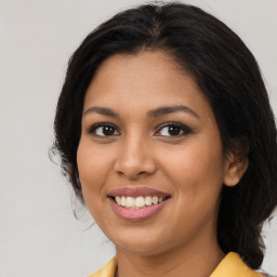 Joyful latino young-adult female with long  brown hair and brown eyes