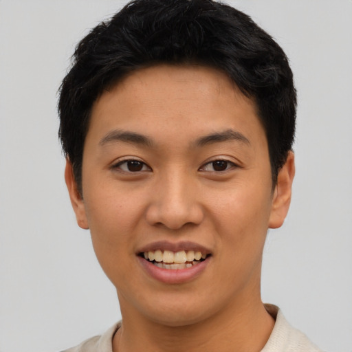 Joyful asian young-adult female with short  black hair and brown eyes