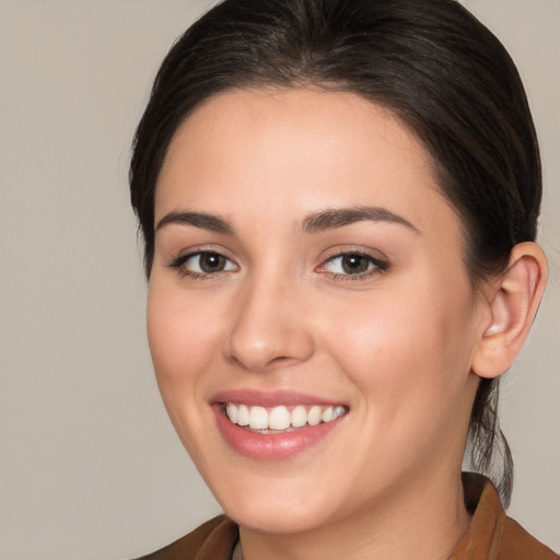 Joyful white young-adult female with medium  brown hair and brown eyes