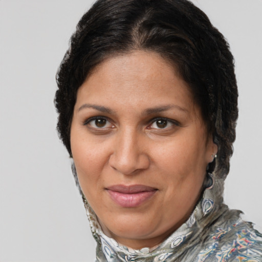 Joyful latino adult female with short  brown hair and brown eyes