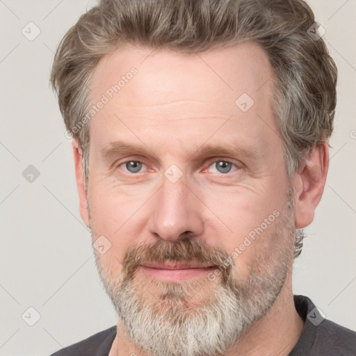 Joyful white adult male with short  brown hair and grey eyes