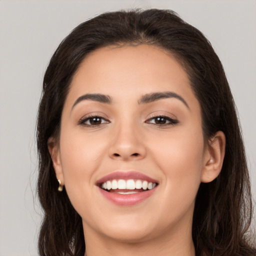 Joyful white young-adult female with long  brown hair and brown eyes