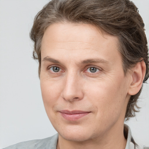 Joyful white adult male with medium  brown hair and brown eyes