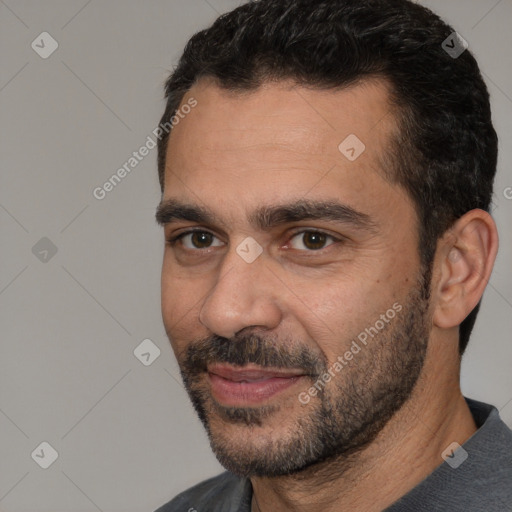 Joyful white young-adult male with short  black hair and brown eyes