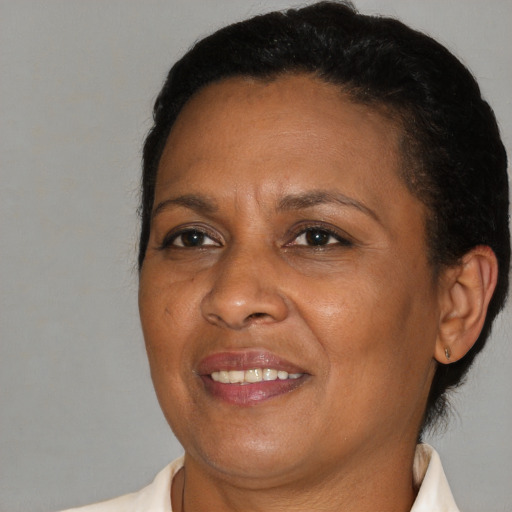 Joyful black adult female with short  brown hair and brown eyes