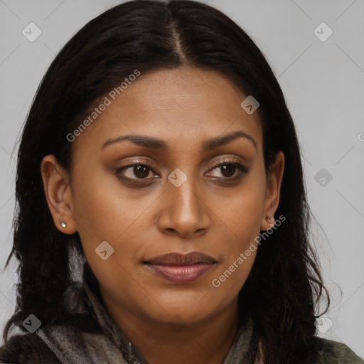 Joyful black young-adult female with long  brown hair and brown eyes