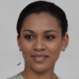 Joyful black young-adult female with short  brown hair and brown eyes