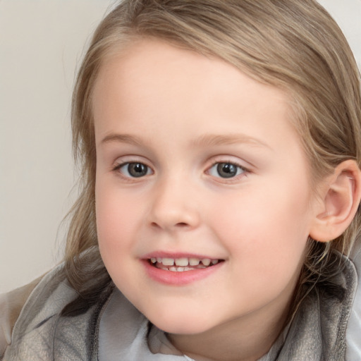 Joyful white child female with medium  brown hair and blue eyes