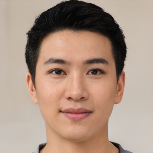 Joyful asian young-adult male with short  black hair and brown eyes