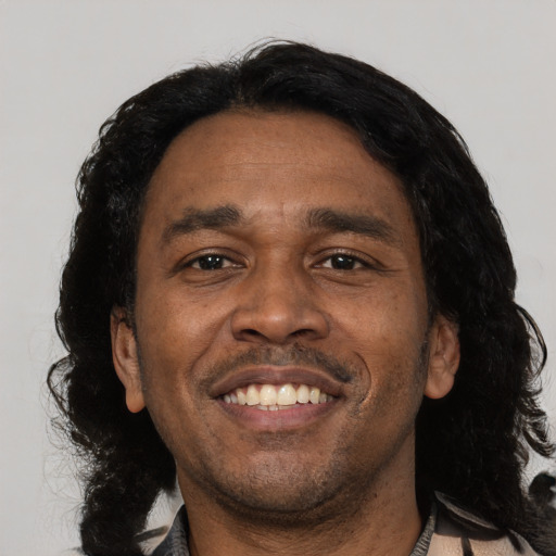 Joyful black adult male with medium  black hair and brown eyes
