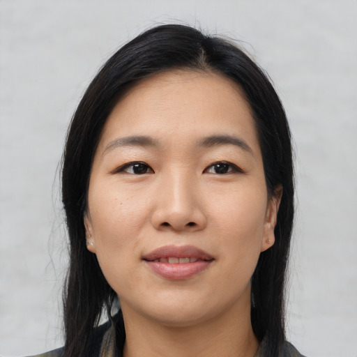 Joyful asian young-adult female with long  black hair and brown eyes