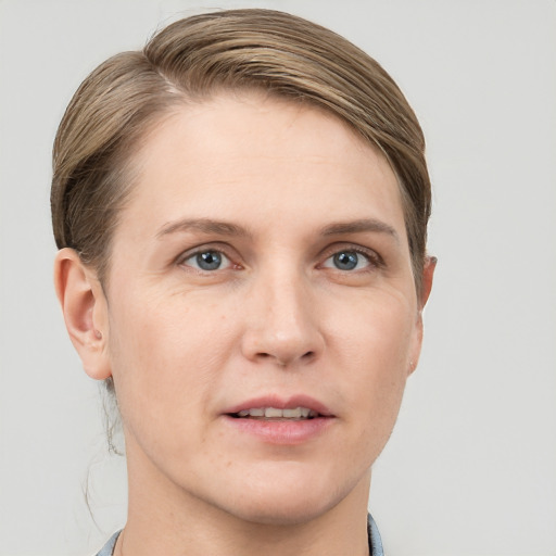 Joyful white young-adult female with short  brown hair and grey eyes