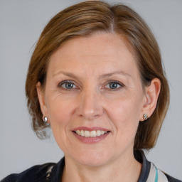 Joyful white adult female with medium  brown hair and grey eyes