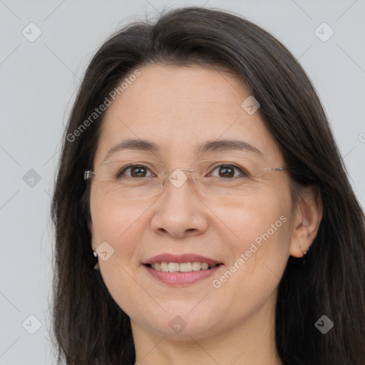 Joyful white adult female with long  brown hair and brown eyes