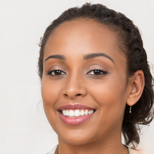 Joyful latino young-adult female with long  brown hair and brown eyes