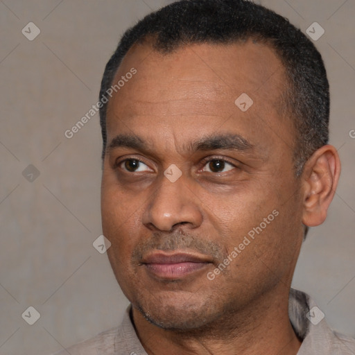 Joyful black adult male with short  black hair and brown eyes