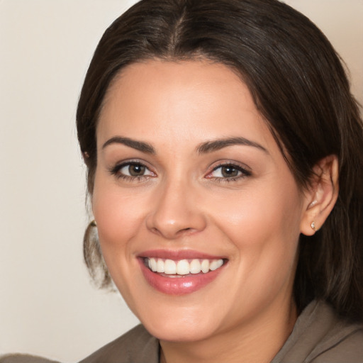 Joyful white young-adult female with medium  brown hair and brown eyes