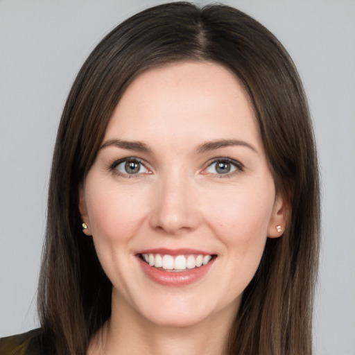 Joyful white young-adult female with long  brown hair and brown eyes