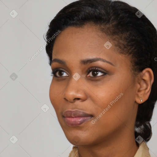 Joyful black young-adult female with short  black hair and brown eyes