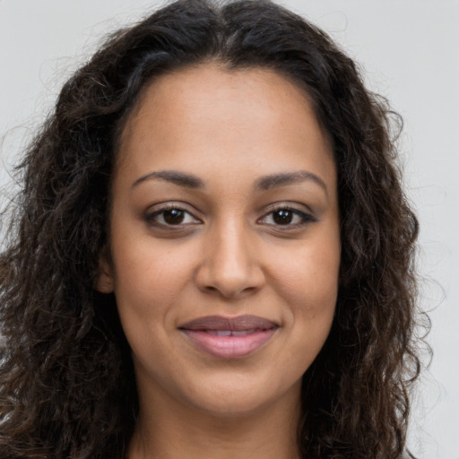 Joyful latino young-adult female with long  brown hair and brown eyes