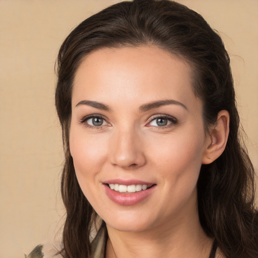 Joyful white young-adult female with long  brown hair and brown eyes