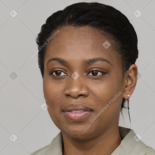 Joyful black young-adult female with short  black hair and brown eyes