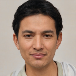 Joyful asian young-adult male with short  black hair and brown eyes