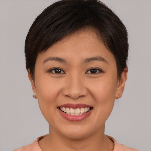 Joyful white young-adult female with short  brown hair and brown eyes