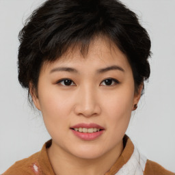 Joyful asian young-adult female with short  brown hair and brown eyes