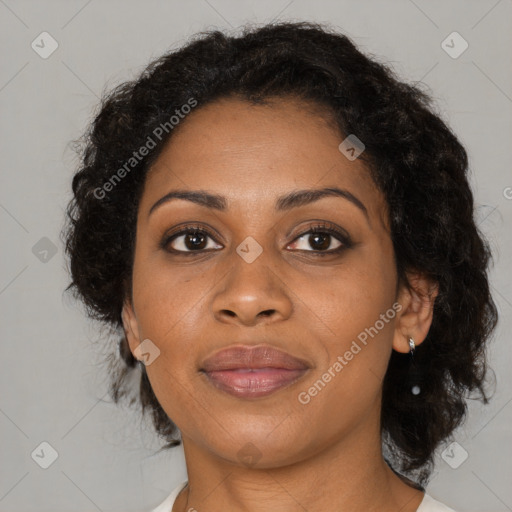 Joyful black adult female with medium  brown hair and brown eyes