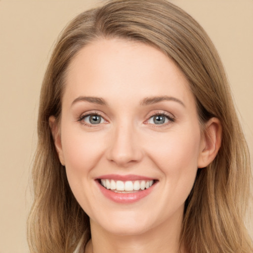 Joyful white young-adult female with long  brown hair and grey eyes