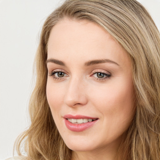 Joyful white young-adult female with long  brown hair and green eyes