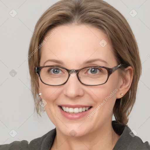 Joyful white adult female with medium  brown hair and grey eyes