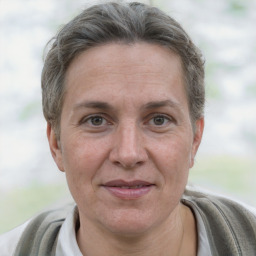 Joyful white adult female with short  brown hair and grey eyes