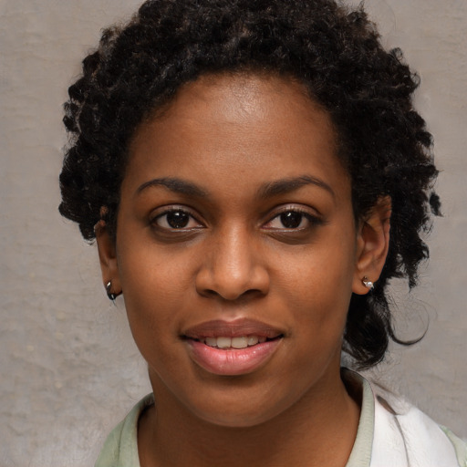 Joyful black young-adult female with medium  black hair and brown eyes