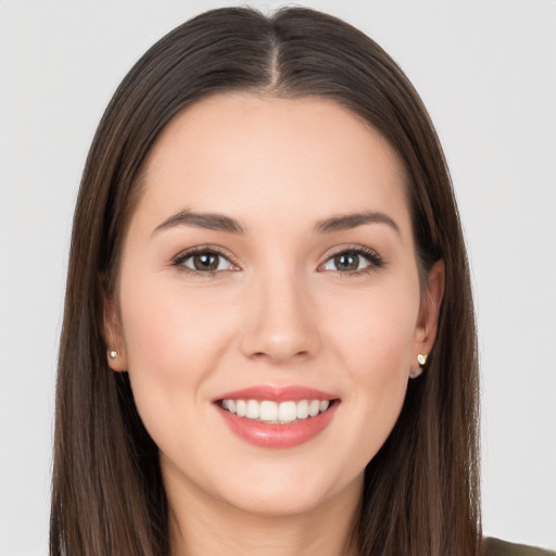 Joyful white young-adult female with long  brown hair and brown eyes