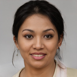 Joyful asian young-adult female with medium  brown hair and brown eyes