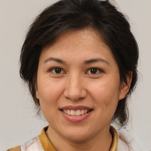 Joyful white adult female with medium  brown hair and brown eyes