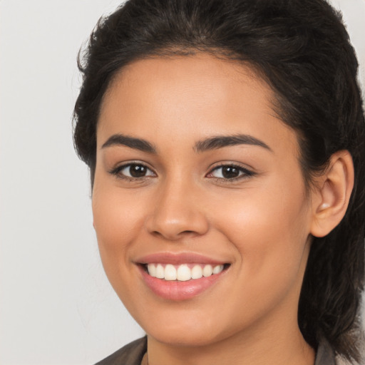 Joyful latino young-adult female with long  brown hair and brown eyes