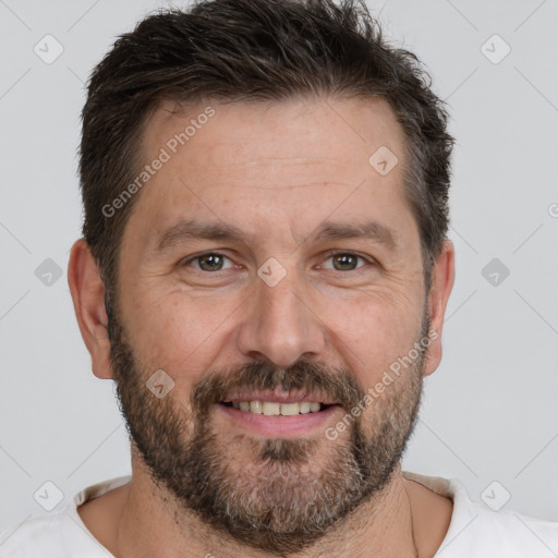 Joyful white adult male with short  brown hair and brown eyes