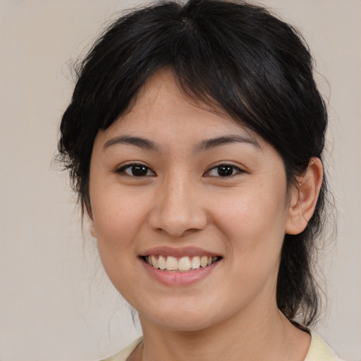 Joyful asian young-adult female with medium  brown hair and brown eyes