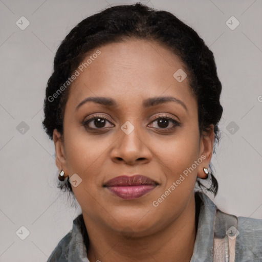 Joyful black young-adult female with long  black hair and brown eyes