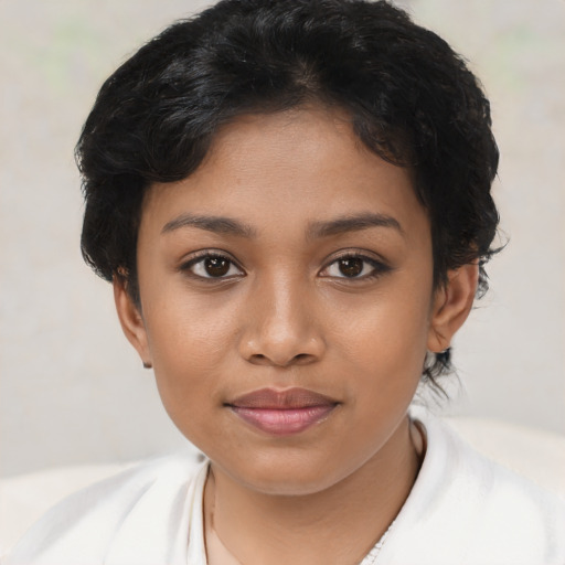 Joyful latino young-adult female with short  brown hair and brown eyes
