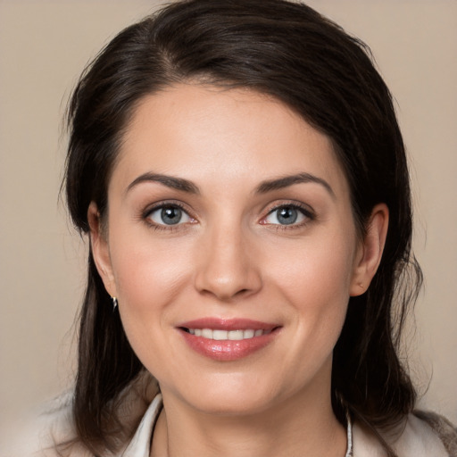 Joyful white young-adult female with medium  brown hair and brown eyes