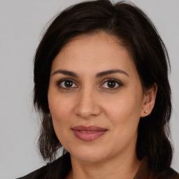 Joyful white adult female with long  brown hair and brown eyes