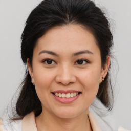 Joyful asian young-adult female with medium  brown hair and brown eyes