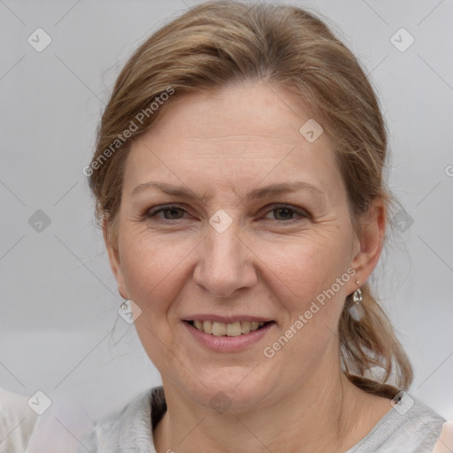 Joyful white adult female with medium  brown hair and grey eyes