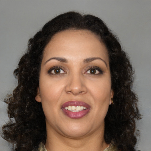 Joyful latino young-adult female with medium  brown hair and brown eyes