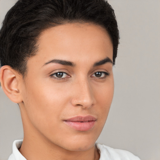 Joyful latino young-adult female with short  brown hair and brown eyes