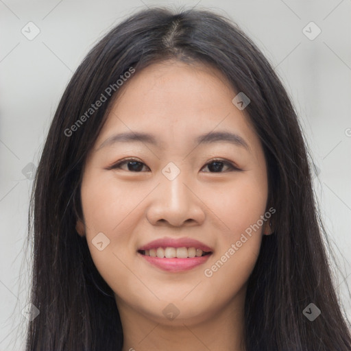 Joyful asian young-adult female with long  brown hair and brown eyes